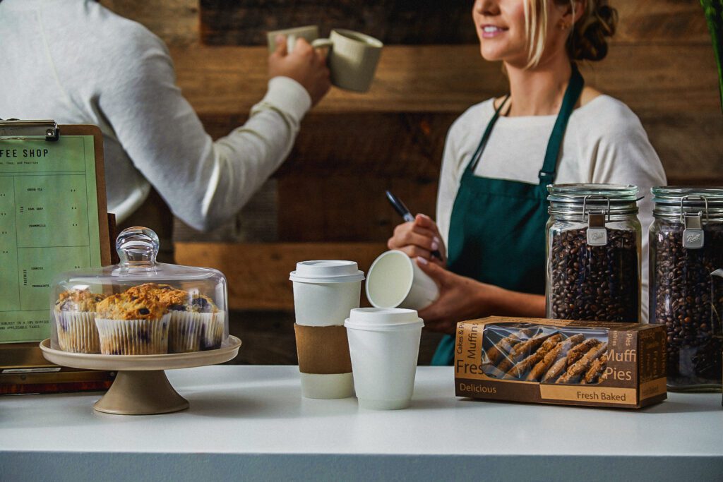 A view of baristas in the back, featuring foodservice packaging