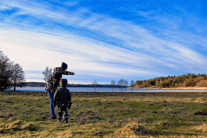 Mother and child in nature pointing