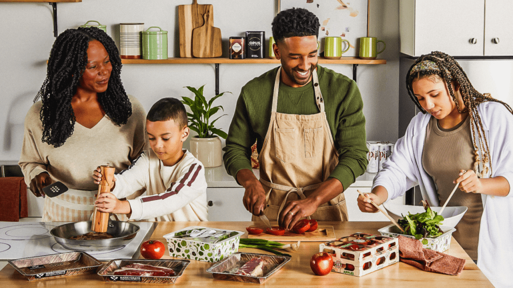 Family cooking with fiber-based food packaging on kitchen counter