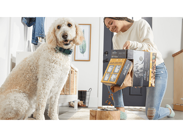 Girl pouring dog food into bowl