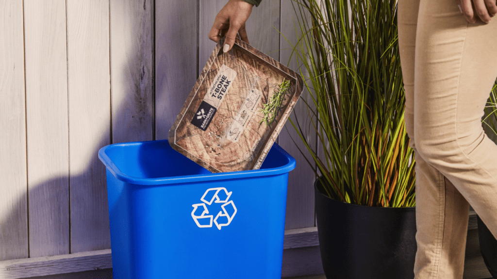 Tray being placed in recycling bin