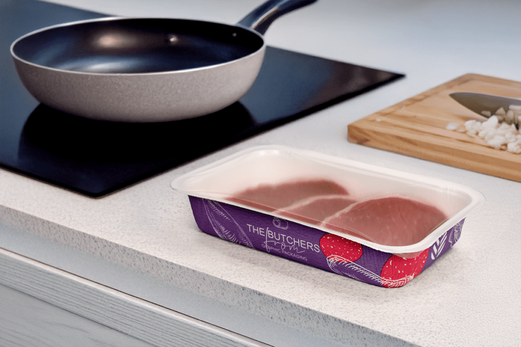 PaperSeal Pressed tray on a kitchen counter with pan and chopped up onion
