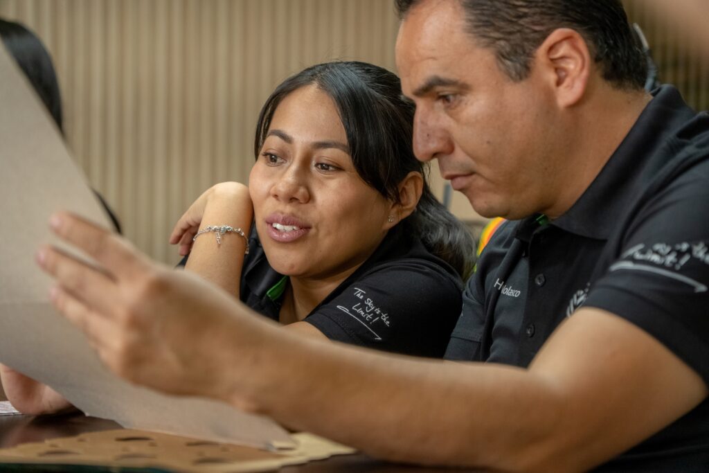 Two employees looking at the packaging they created