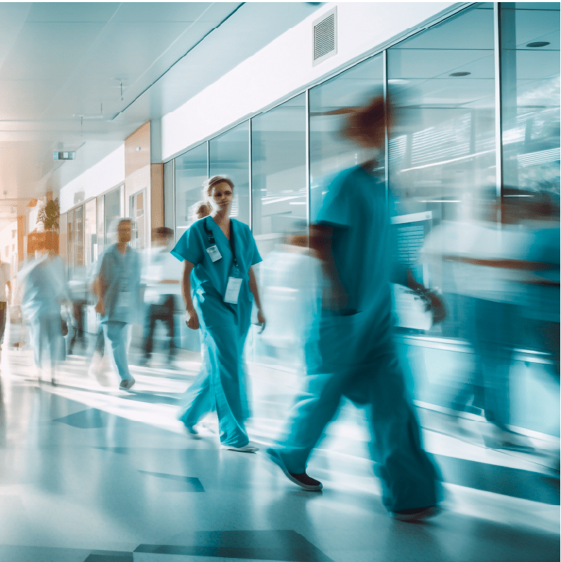 Hospital interior abstract background. Long exposure blurred motion of medical doctors and nurses in a hospital ward walking down a corridor.
