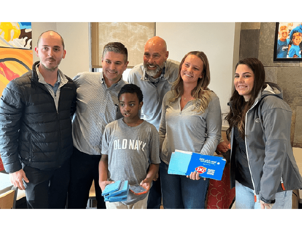 Isaiah and his family receive their blue fry cartons from Graphic Packaging