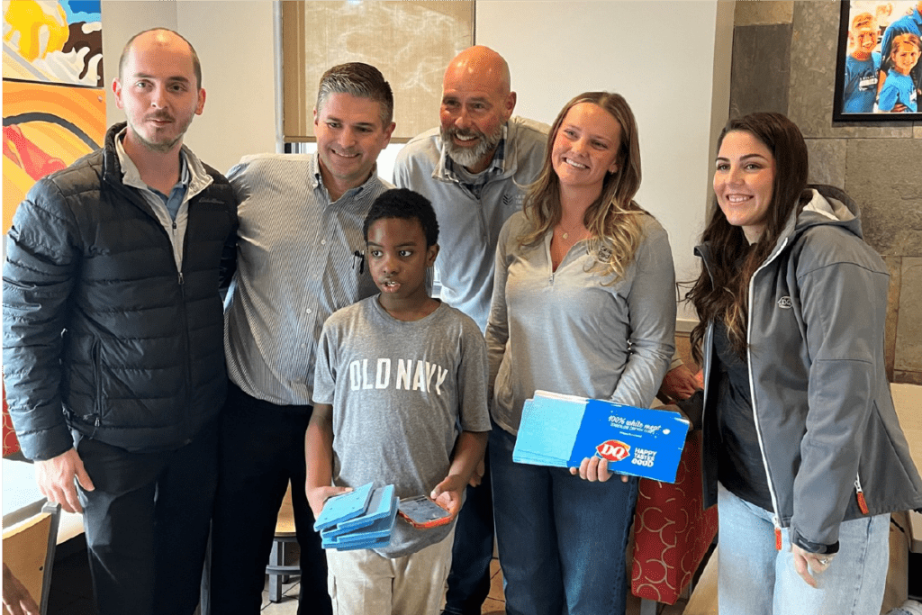 Isaiah and his family receive their blue fry cartons from Graphic Packaging