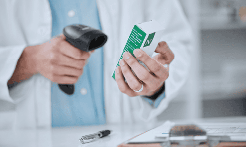 Person, pharmacist and hands scanning box in price check, inventory or inspection on medication at pharmacy